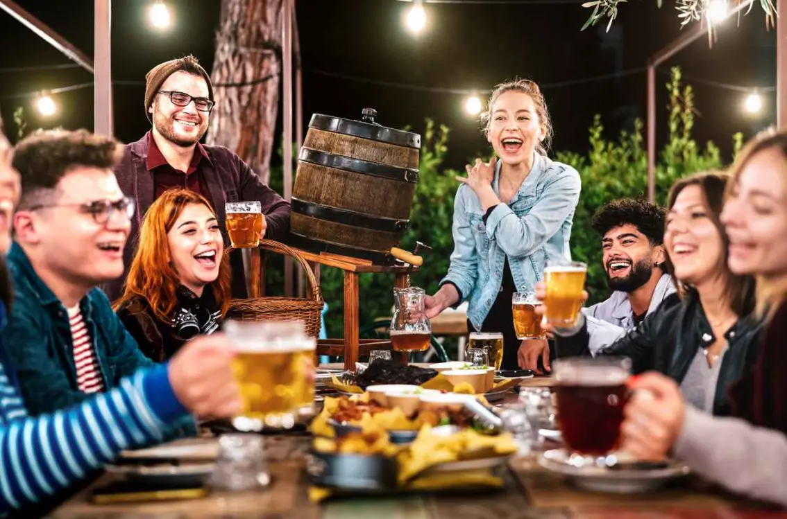 Friends enjoying each other while having drinks and food.