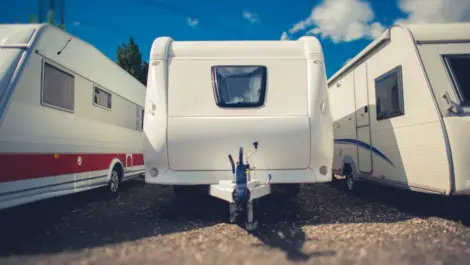 Campers and RVs parked in a row.