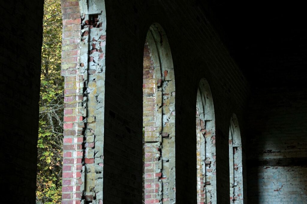 A row of arched windows from an old brick torpedo warehouse in Manchester State Park in Washington.