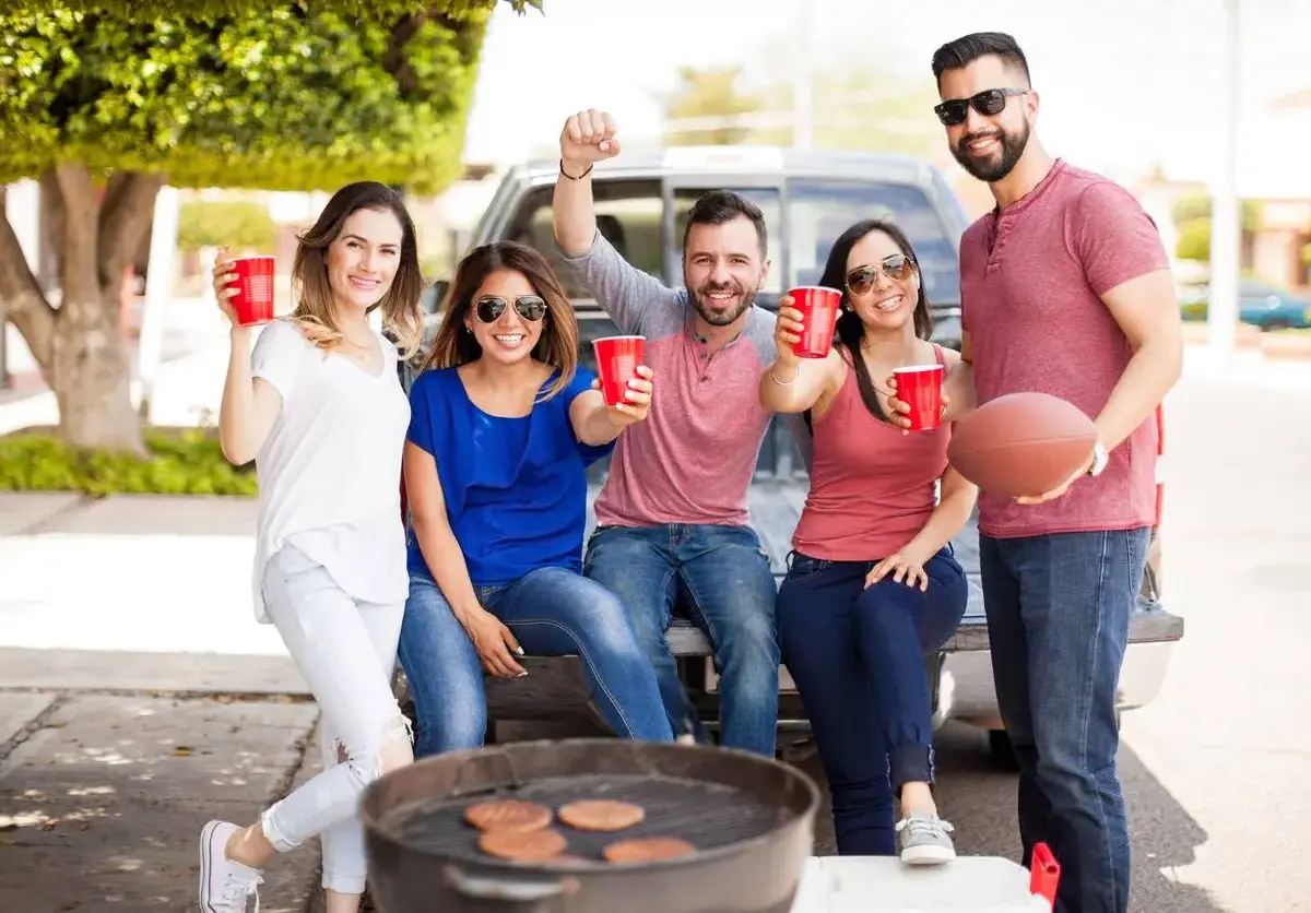 A group of tailgaters enjoying each other's company.