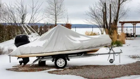 A fishing boat is wrapped in a protective cover for the winter.