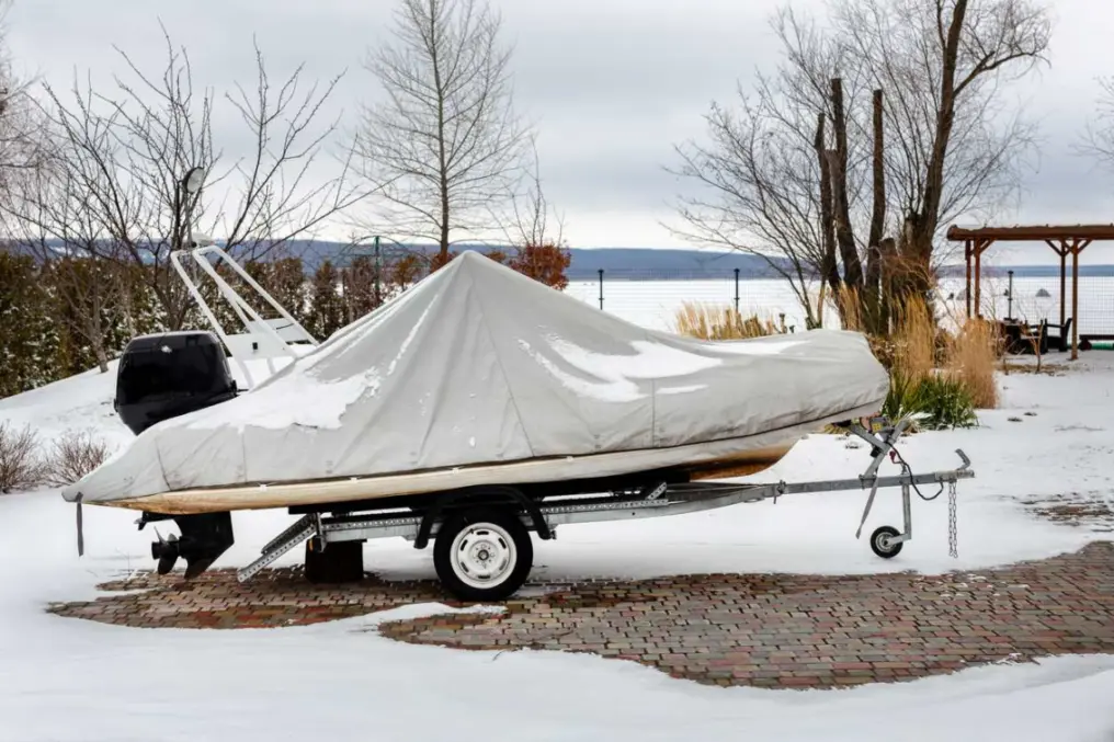 A fishing boat is wrapped in a protective cover for the winter.