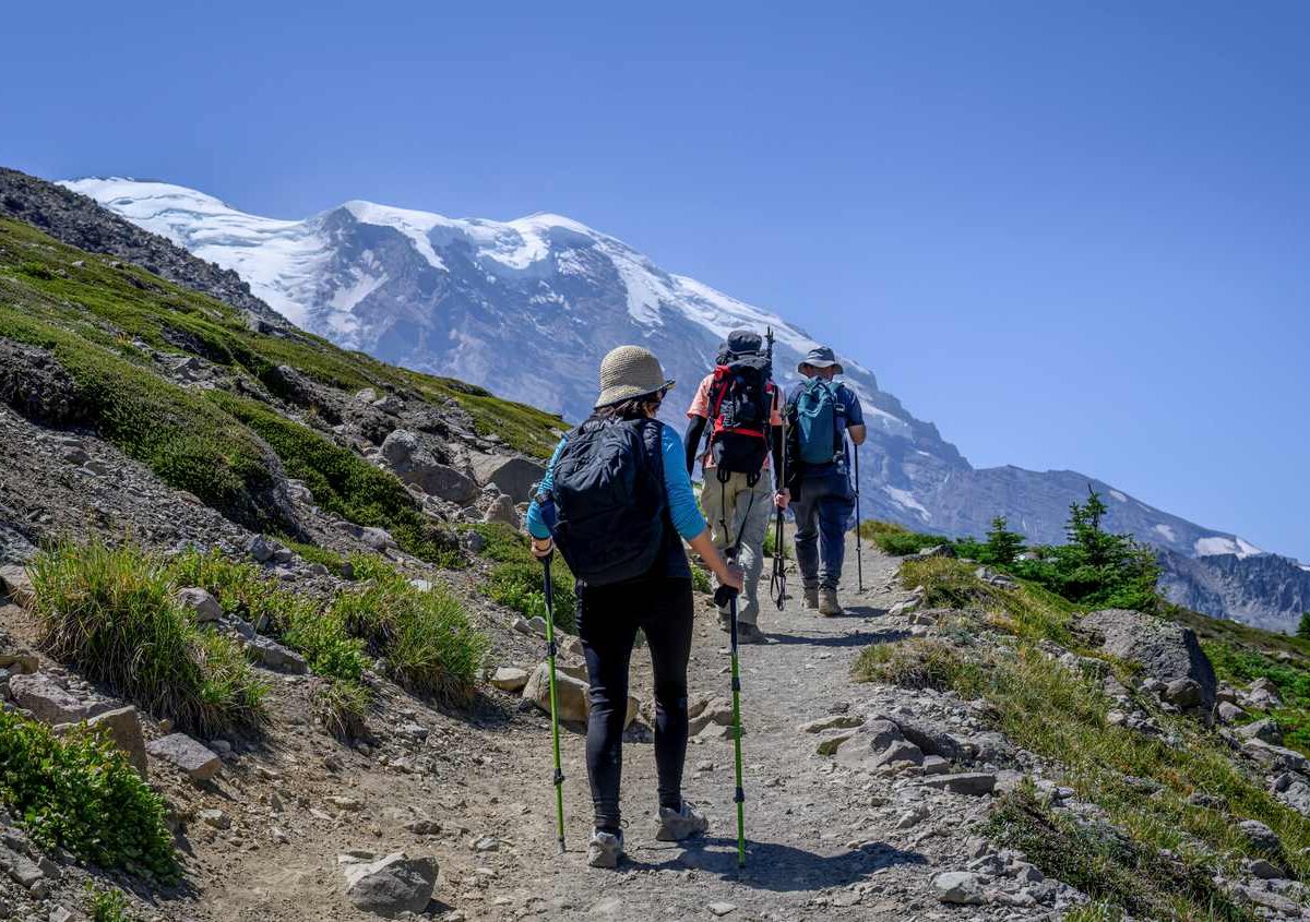 Three people hiking a mountain trail in Washington State.