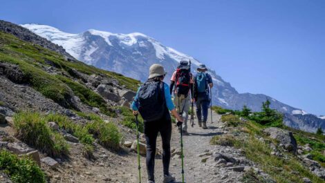 Three people hiking a mountain trail in Washington State.