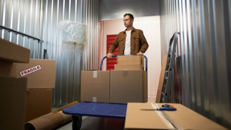 man unloading boxes in a storage unit